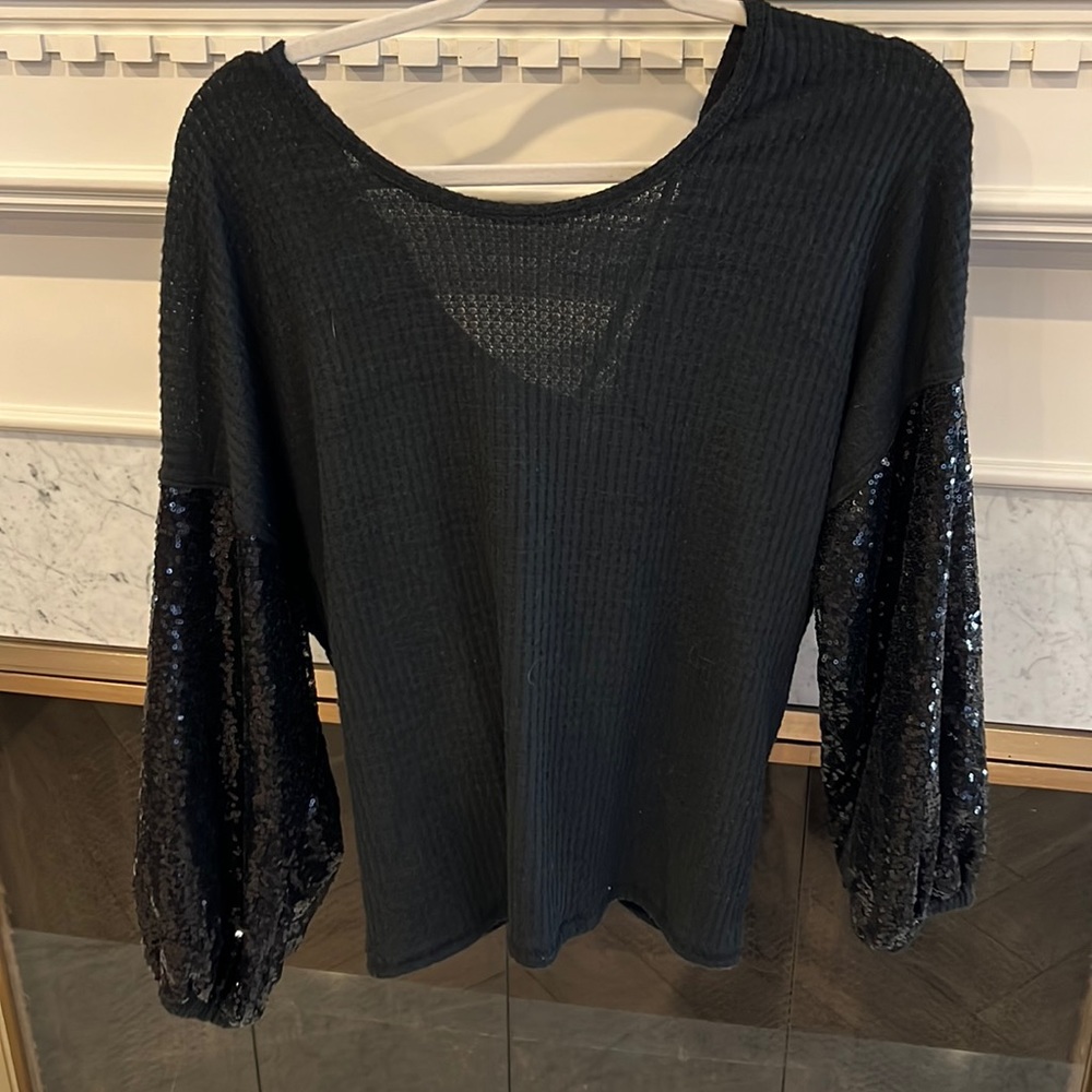 Black long sleeve shirt with sparkle sleeves. polyester, Rayon, and spandex